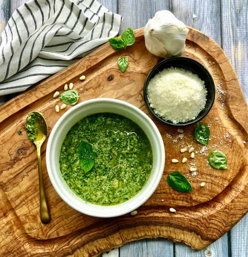 overhead view of pesto in a white bowl comparing pesto and chimichurri
