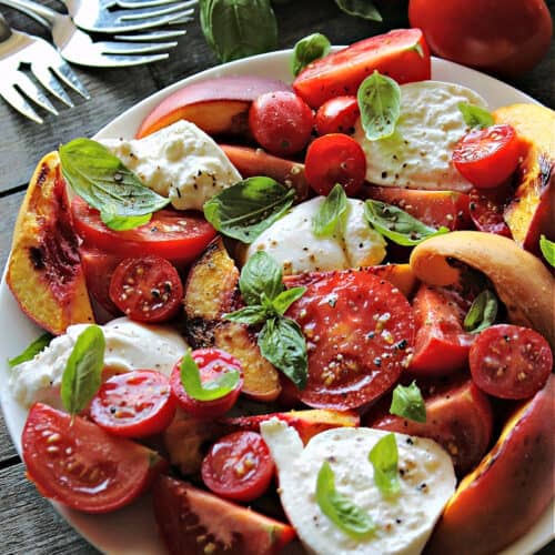overhead view white plate with grilled peach caprese, small plates and forks on the side