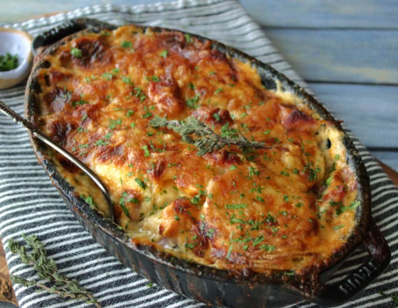 black casserole dish with scalloped potatoes and ham