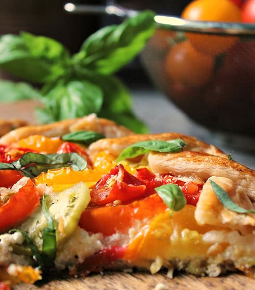 sliced tomato galette on parchment paper