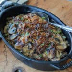 black casserole dish with small batch green bean casserole topped with caramelized onions