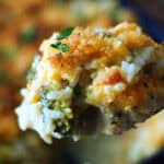 closeup spoon of chicken casserole showing broccoli and rice