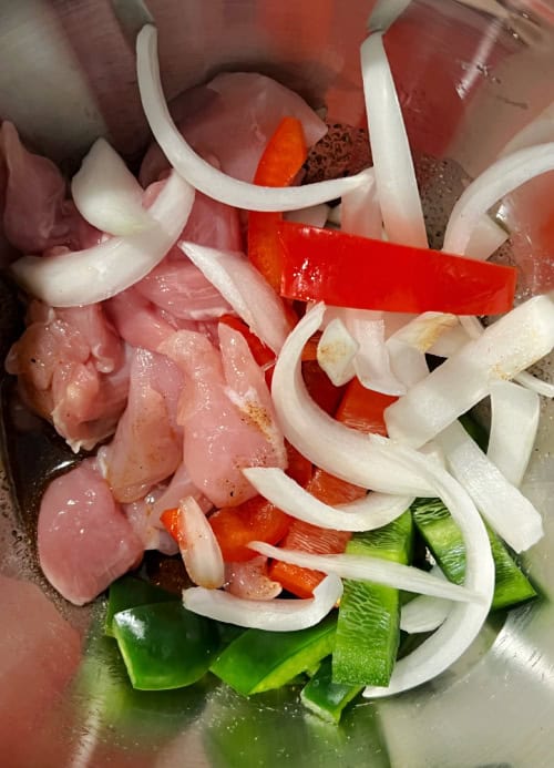 raw air fryer chicken fajitas with vegetables in a bowl