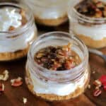 no bake pecan pie cheesecake jars in mini mason jars garnished with whipped cream