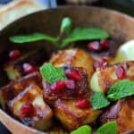 bread cheese vs halloumi - shown in copper bowl garnished with pomegranate seeds and mint leaves