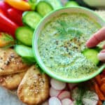 Greek Goddess Dip with cucumber slice dipped into it
