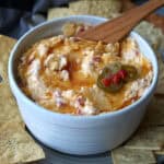 white bowl with hot honey pimento cheese dip garnished with pickled jalapeno