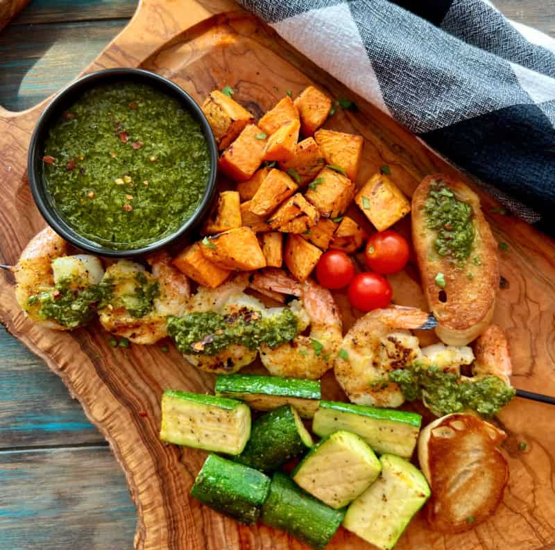 overhead view of board with chimichurri - what's the difference pesto and chimichurri