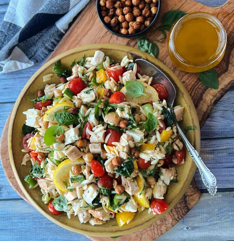 overhead view of lemon chicken orzo salad and small bowl of crispy chickpeas