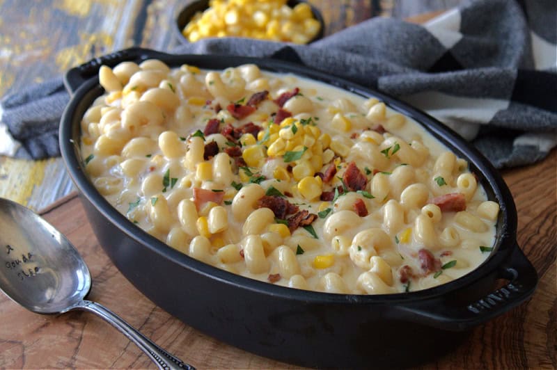 black casserole dish with smoked gouda mac and cheese with corn and bacon