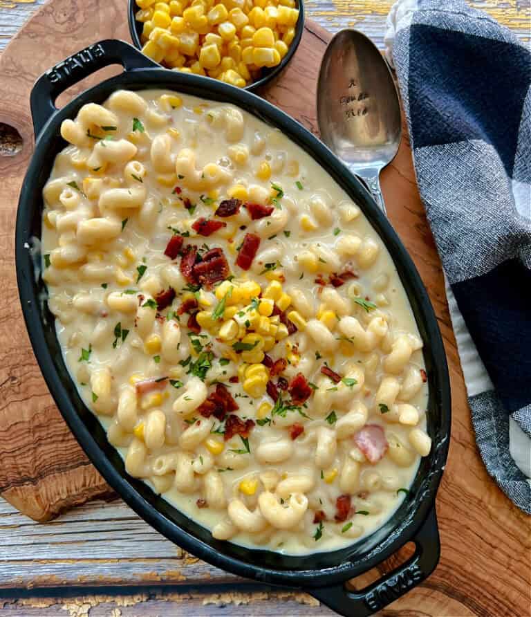overhead view - black casserole dish with smoked gouda mac and cheese garnished with crispy bacon