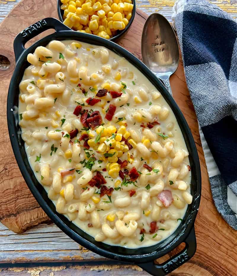 overhead view - black casserole dish with smoked gouda mac and cheese garnished with crispy bacon