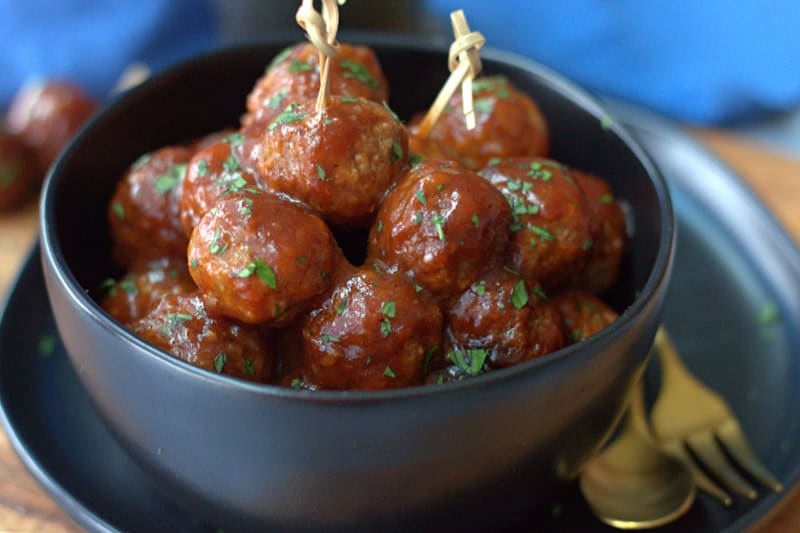black bowl with 3 ingredient meatballs garnished with chopped parsley