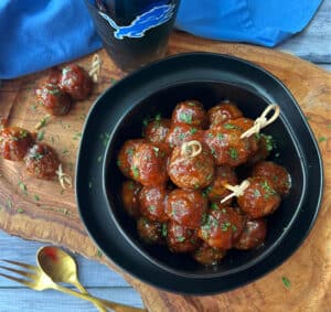 overhead view - black bowl with 3 ingredient meatballs and toothpicks