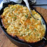 overhead view black serving dish with Crock Pot Corn Casserole and spoon scooping out