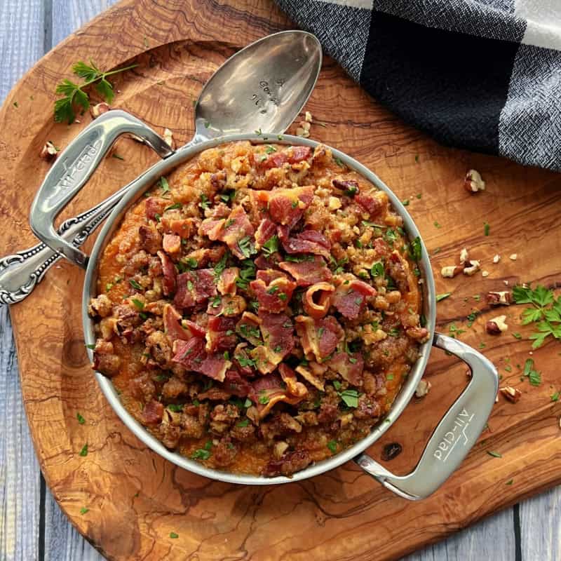 overhead view mashed sweet potatoes topped with brown sugar, pecans and bacon