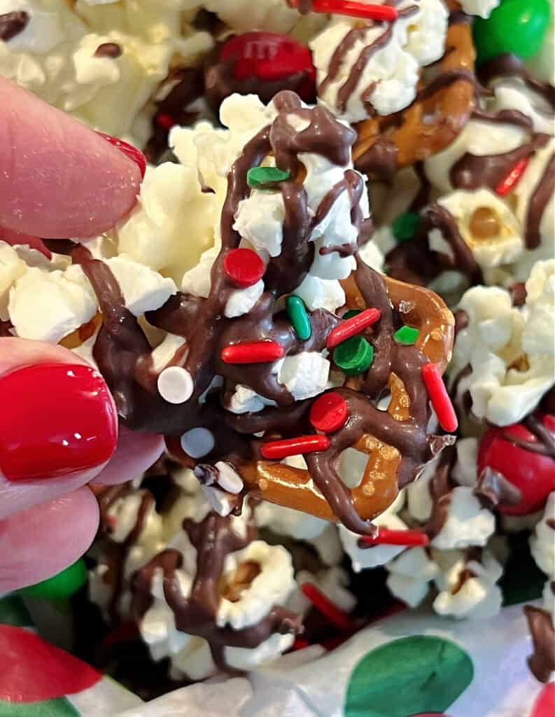 closeup of fingers holding Christmas Popcorn