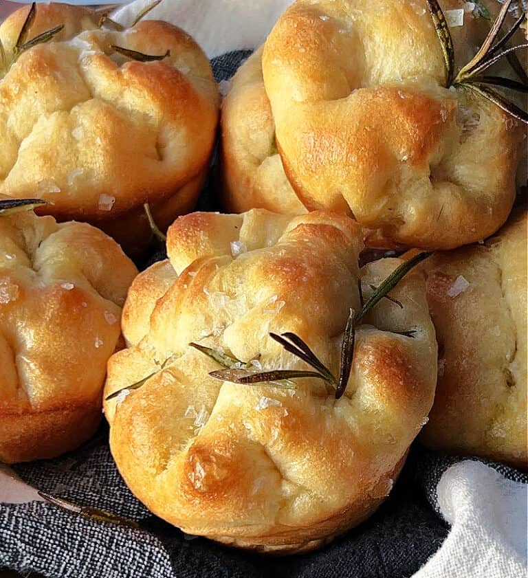 close up of focaccia muffins with fresh rosemary