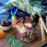 closeup of individual charcuterie cups and breadsticks on the side