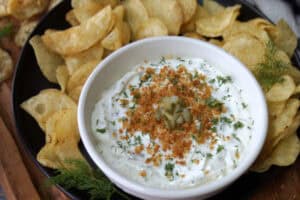 overhead view - white bowl with dill pickle ranch dip topped with golden panko crumbs