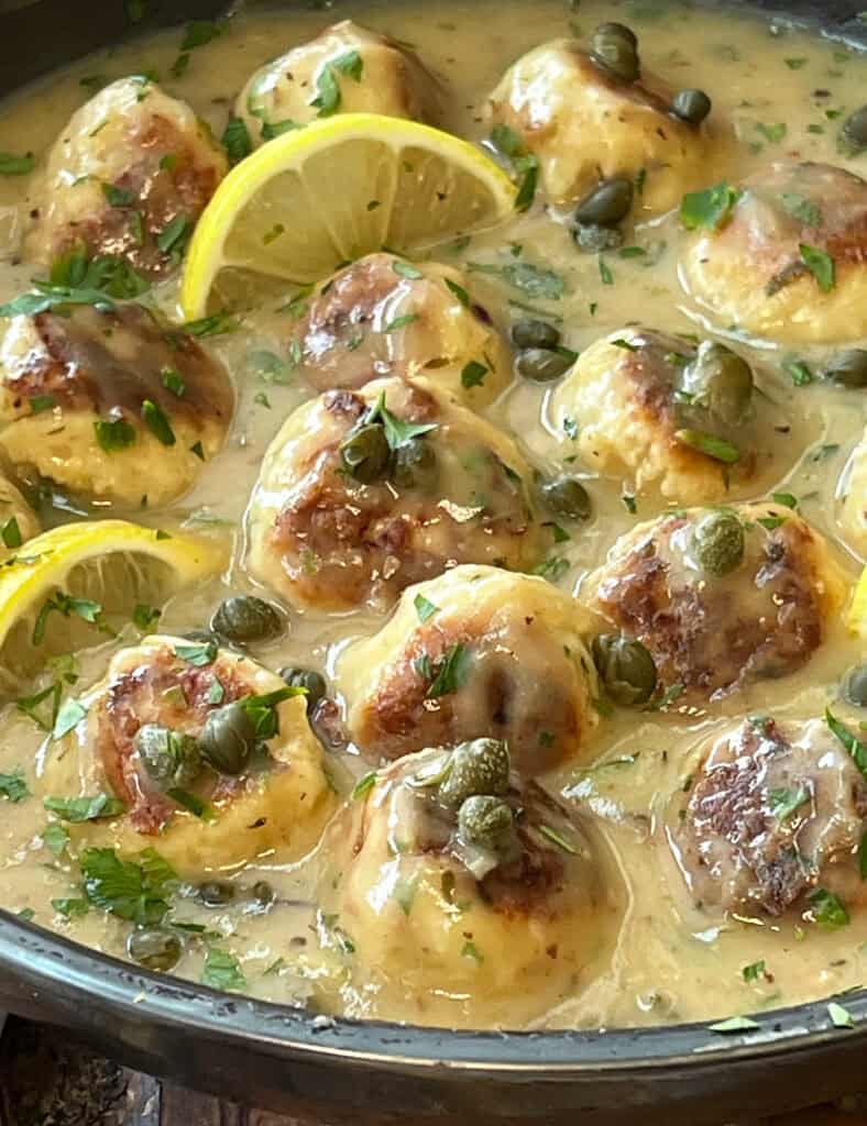 closeup of chicken piccata meatballs in a skillet