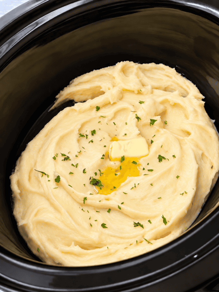 overhead view of crockpot containing slow cooker mashed potatoes
