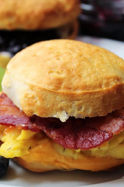 air fryer biscuit breakfast sandwich with scrambled eggs and slices of bacon