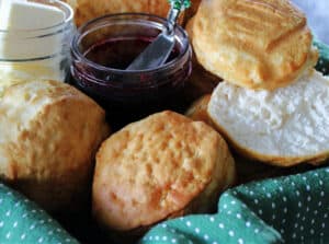 basket with air fryer biscuits and a jar of jam