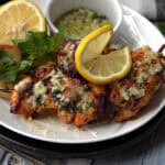 white plate with Air Fryer Garlic Parmesan Chicken Skewers garnished with lemon