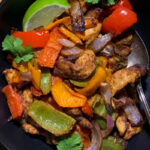 black bowl filled with air fryer chicken fajitas mixture