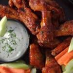 black plate with air fryer frozen chicken wings with buffalo sauce