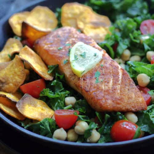 black plate with air fryer salmon and mixed green salmon