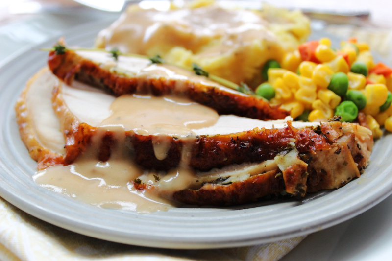slices of air fryer turkey breast with potatoes and gravy