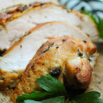 golden air fryer turkey breast sliced on cutting board