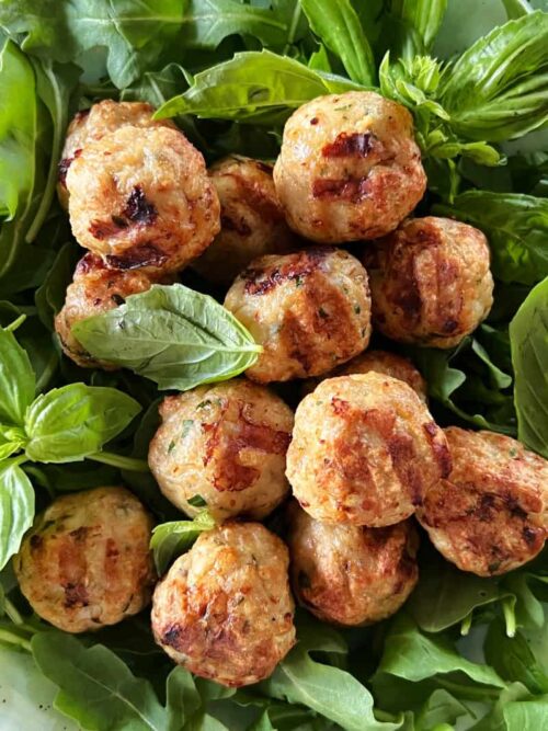 air fryer turkey meatballs in a bed of arugula