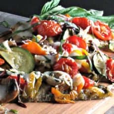 Veggie Flatbread Pizza on Stonefire naan, topped with pesto, roasted vegetables and cheese. Easy, delicious lunch or dinner.