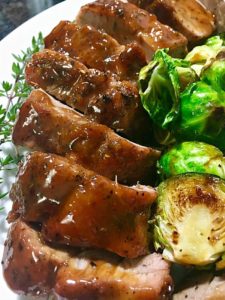 sliced apricot glazed pork tenderloin with brussels sprouts
