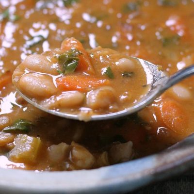 bean with bacon soup ~ bowl of soup with spoonful showing close up of beans.