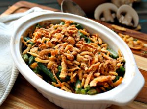 white casserole dish with green bean casserole topped with French's fried onions