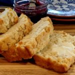 loaf of beer bread sliced with butter