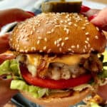 closeup of Best Grilled Chicken Burger with caramelized onions and chipotle mayo