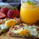 Best breakfast sliced in half served with strawberries and orange juice.