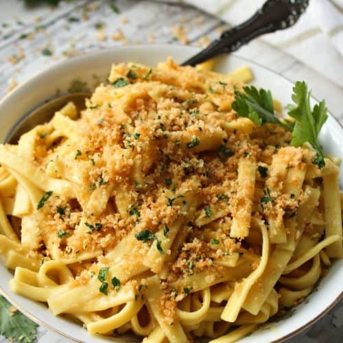 bowl of buttered noodles with spoon