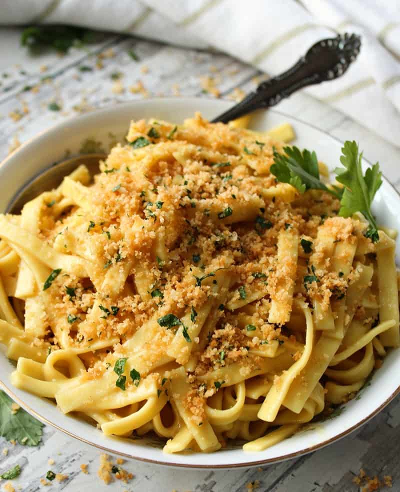 bowl of buttered noodles with spoon