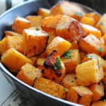 black bowl with air fryer butternut squash garnished with parsley