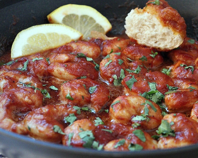 spicy new orleans style shrimp ~ cooked shrimp in spicy sauce in the skillet plus lemon wedge and crusty bread.