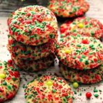 red and green sprinkled cookies stacked on a white board