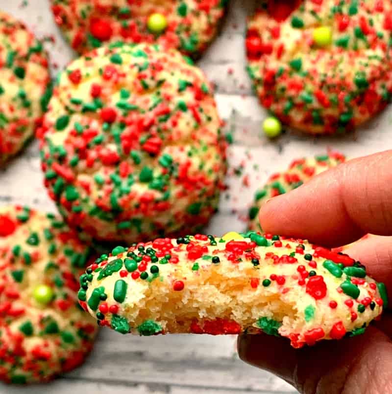 close up of red and green sprinkle cookie with bite taken out of it.