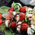 6" caprese skewers with grape tomatoes, mozzarella, basil and balsamic glaze.