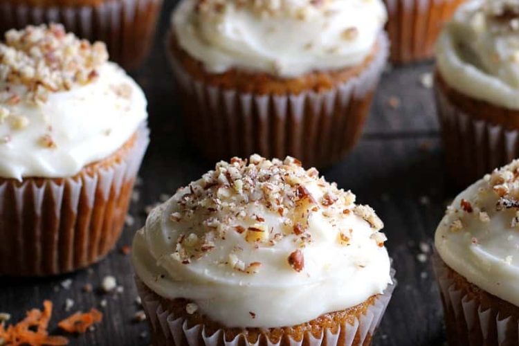 carrot cake cupcakes sprinkled with pecans